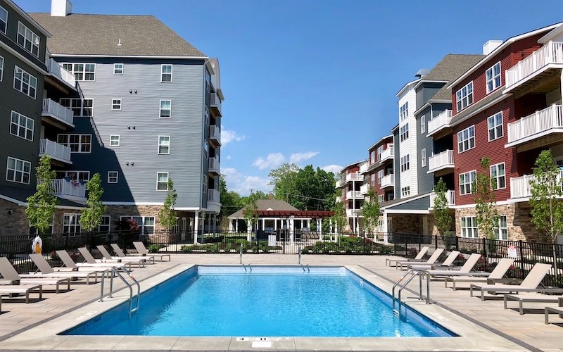 resort-style pool in a courtyard with lounge chairs